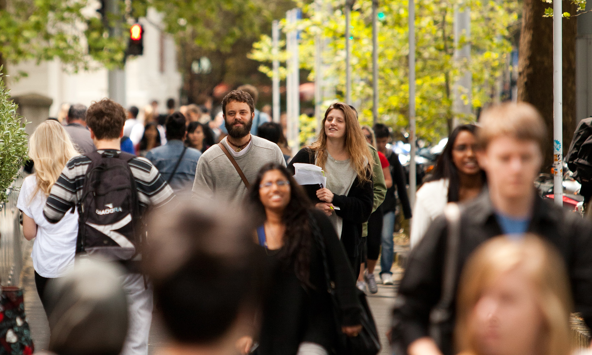 Tertiary students walking outside the University of Auckland.